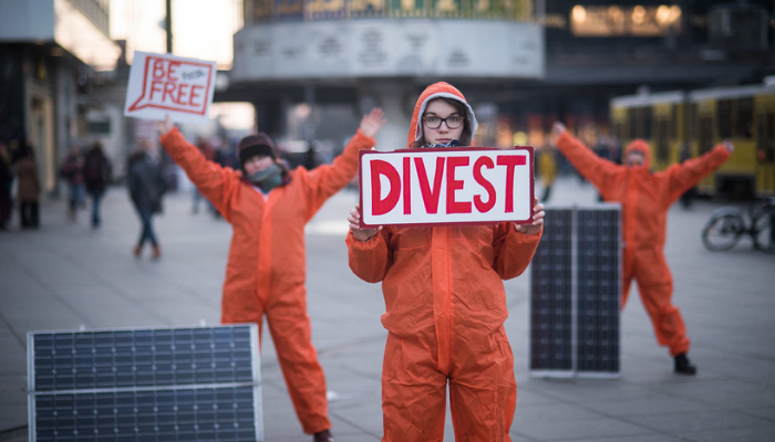 Picture of people holding a divest sign