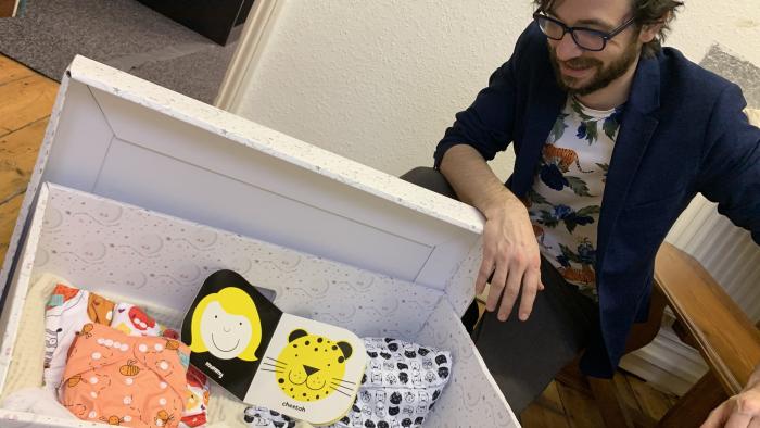 Picture of a man looking into a sustainable baby box