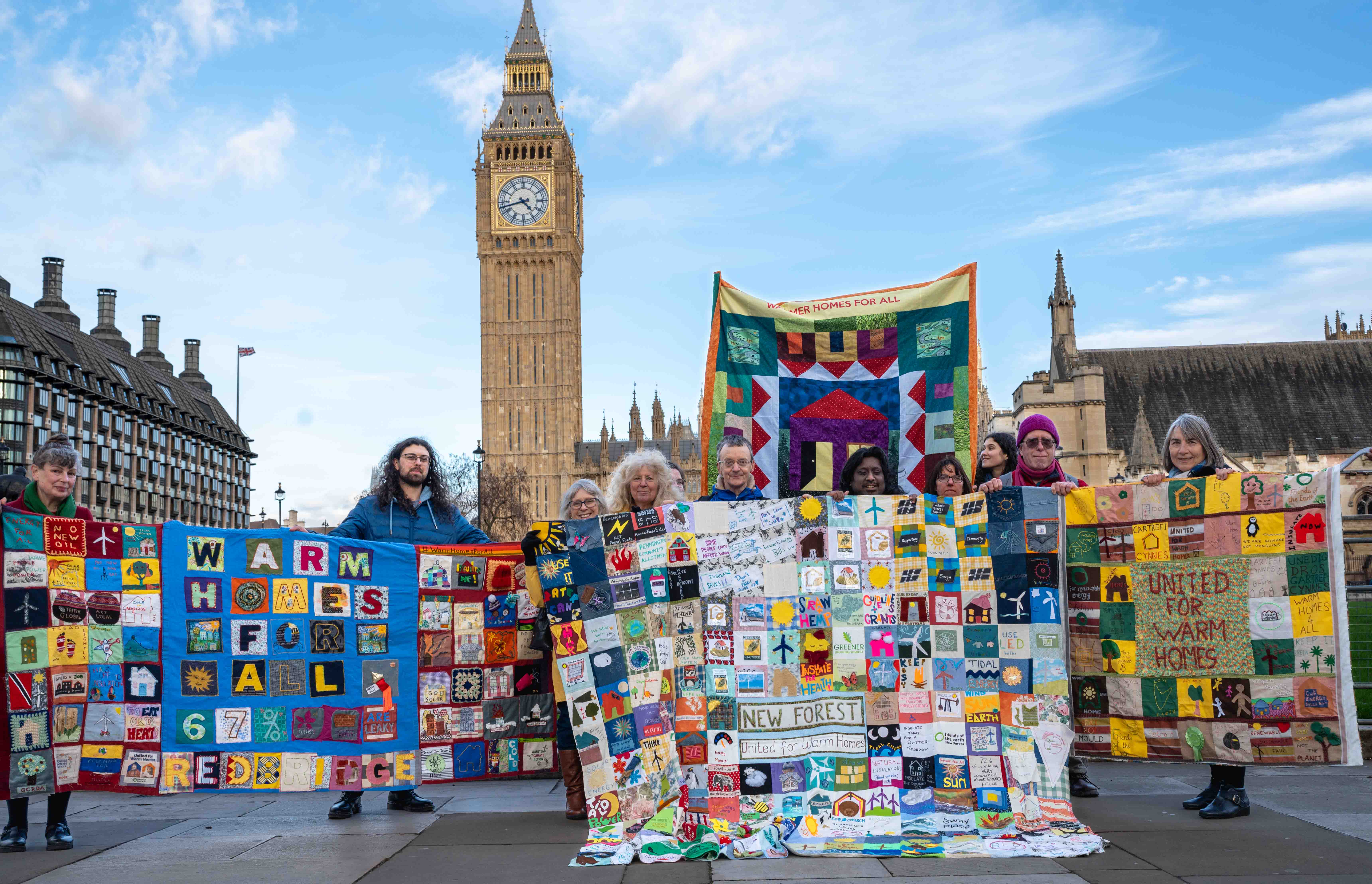 People with community quilts outside Westminster