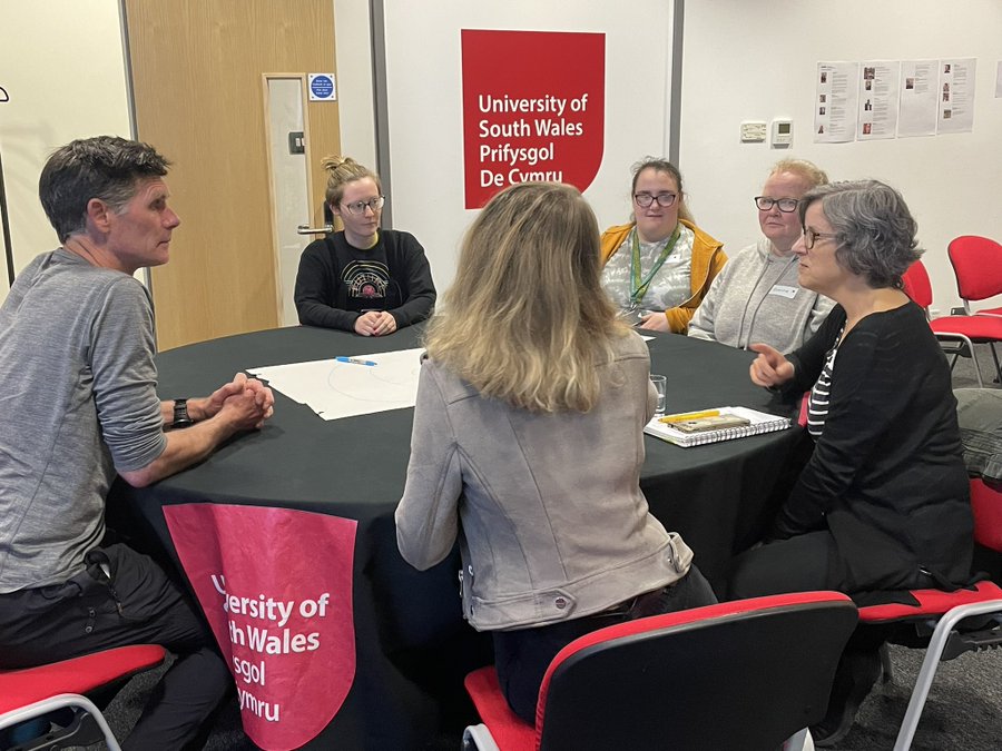 People chatting around a table at an event