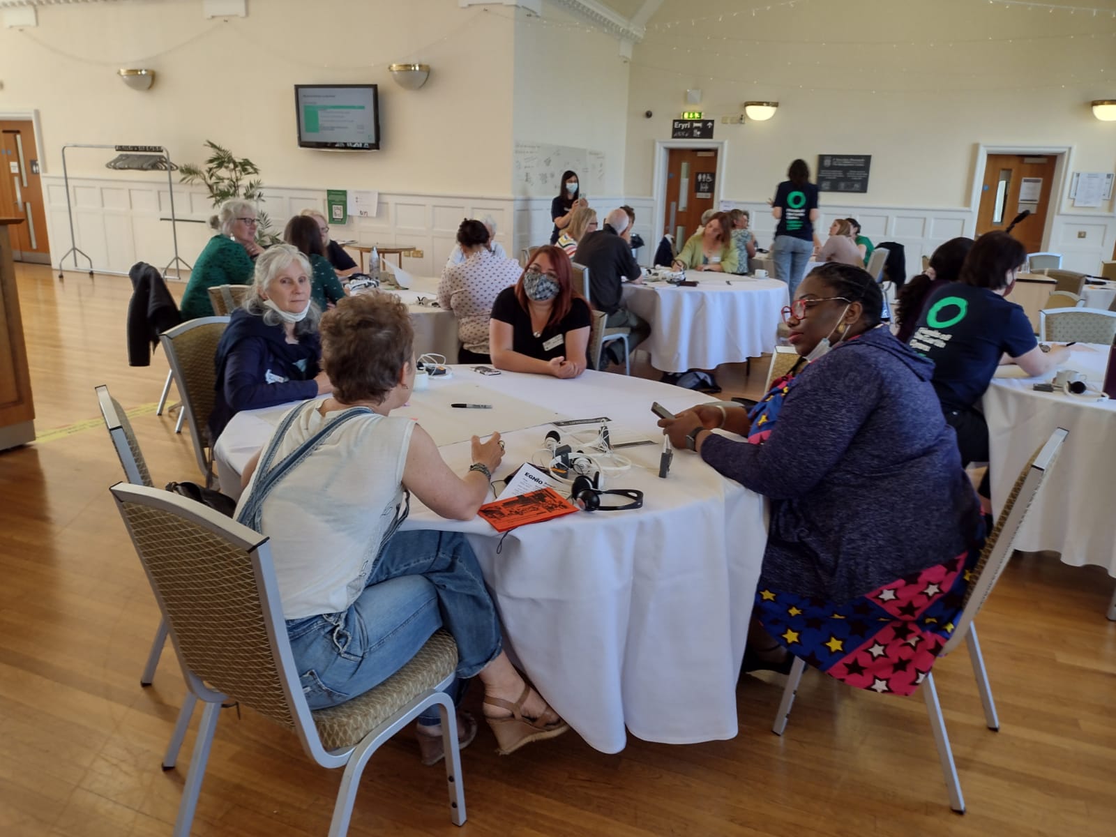 People chatting around a table at an event