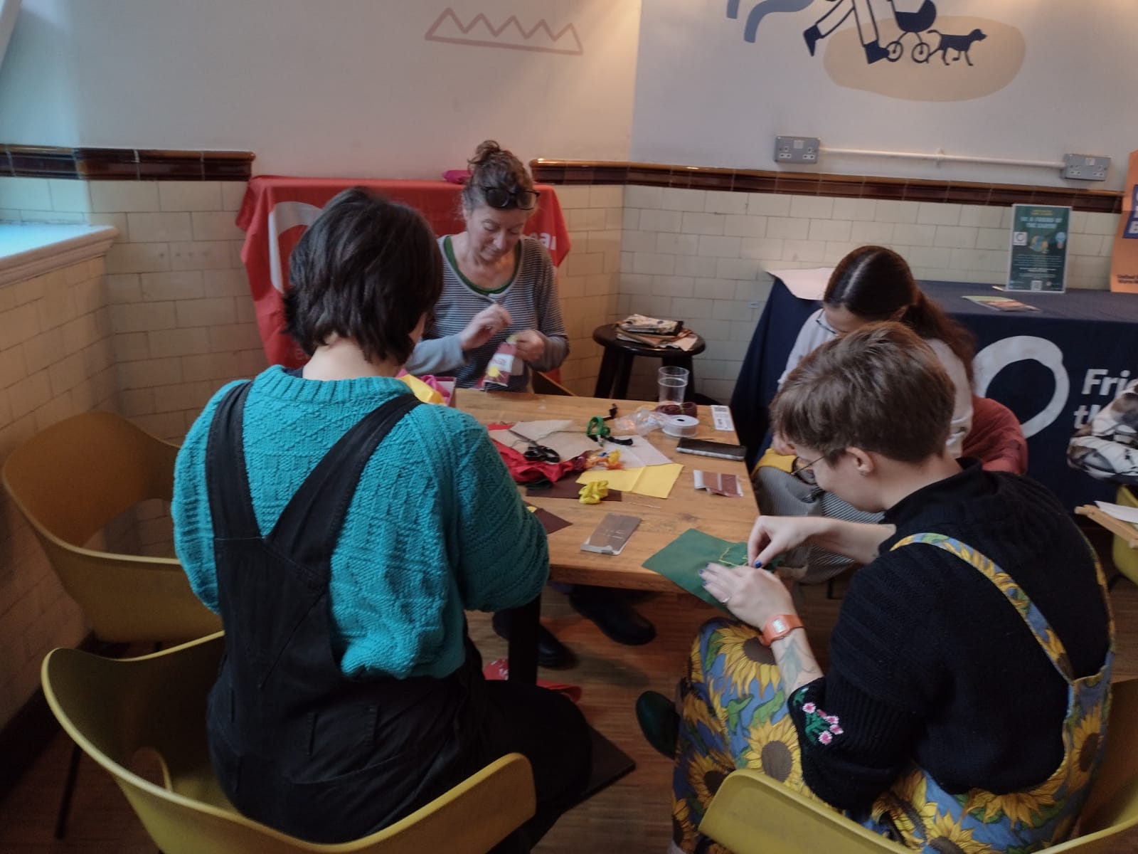 People sitting around a table making quilts