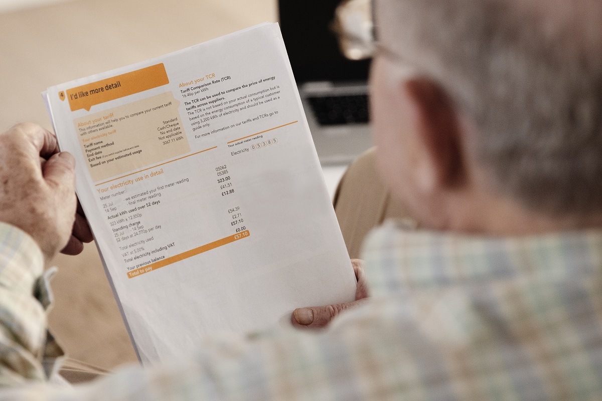 Elderly man reading electricity bill