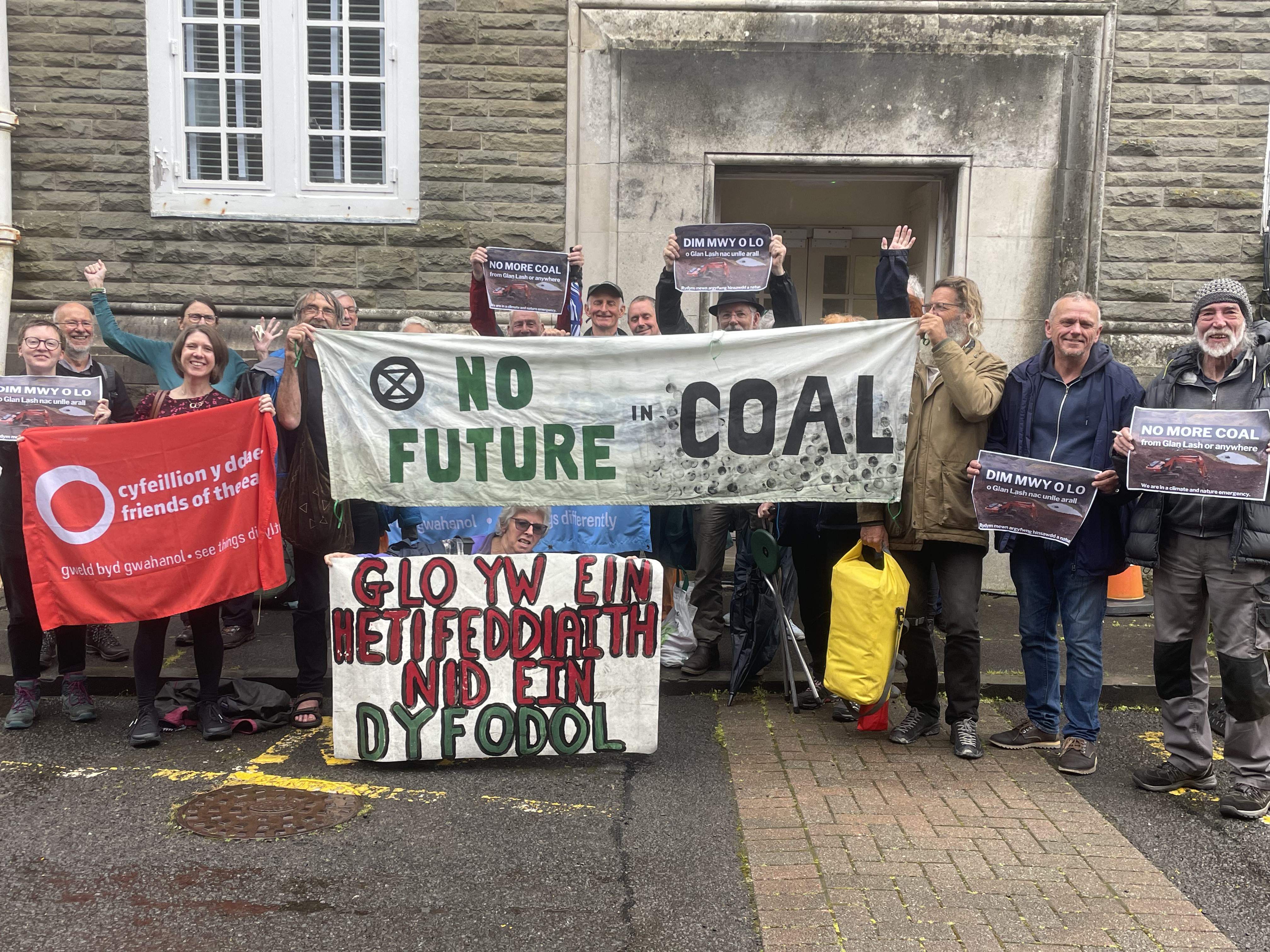 Campaigners holding up placards on steps