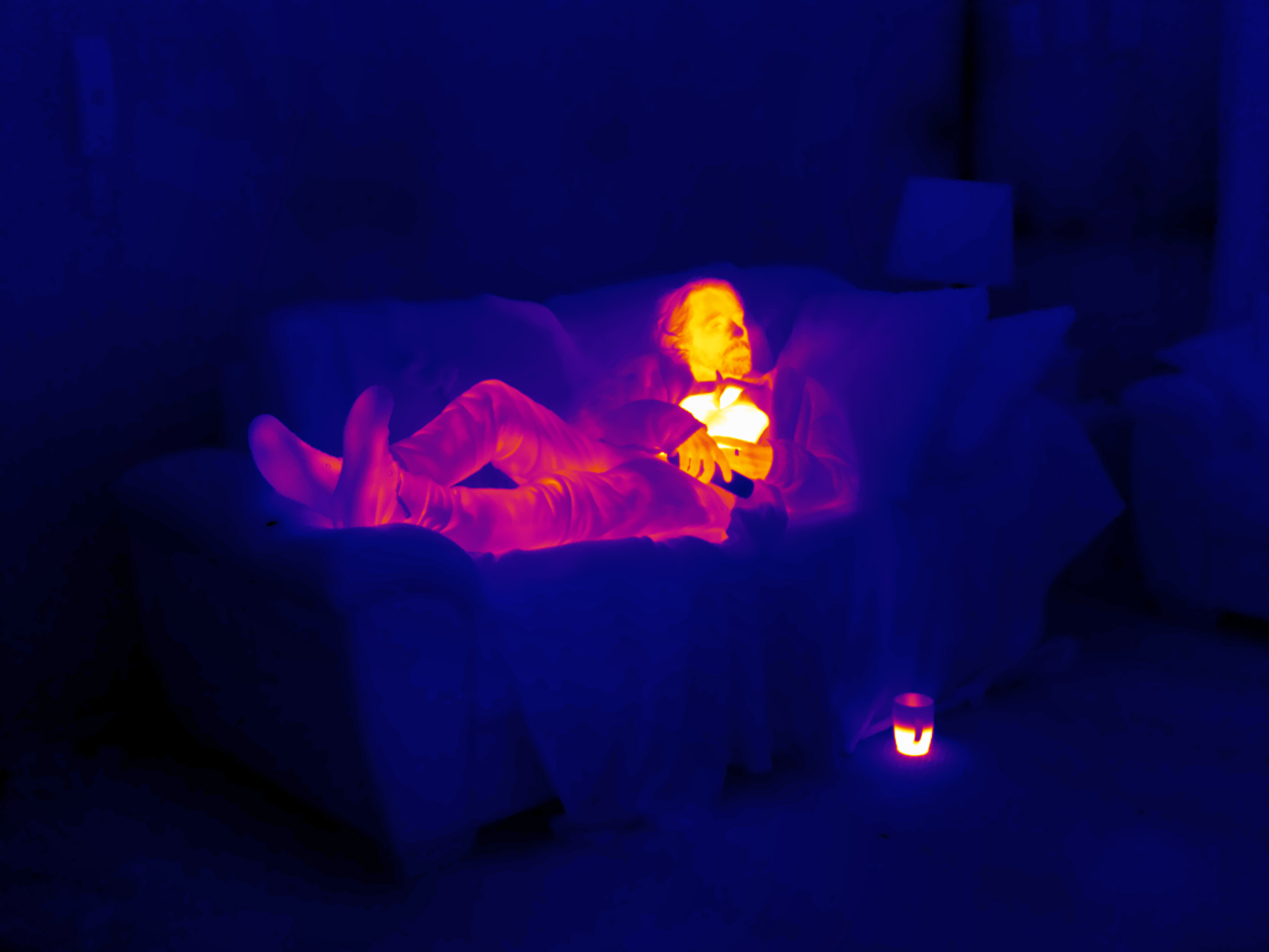 Thermal image of a man lying on a sofa
