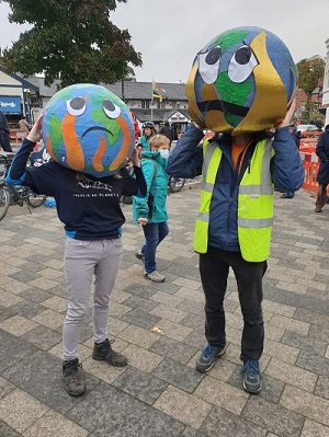 People wearing Earth heads