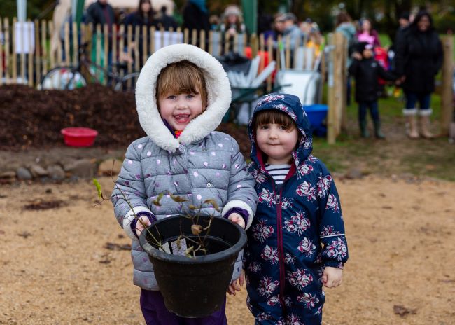 Two children planting Tiny Forest Caerffili