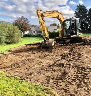 Taking off the top soil with a digger