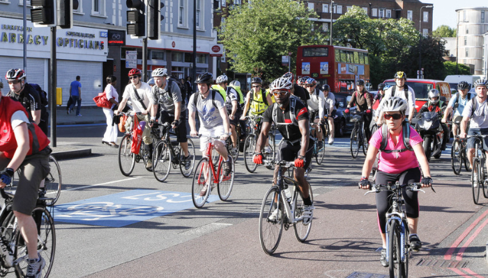 Picture of people cycling on a main road