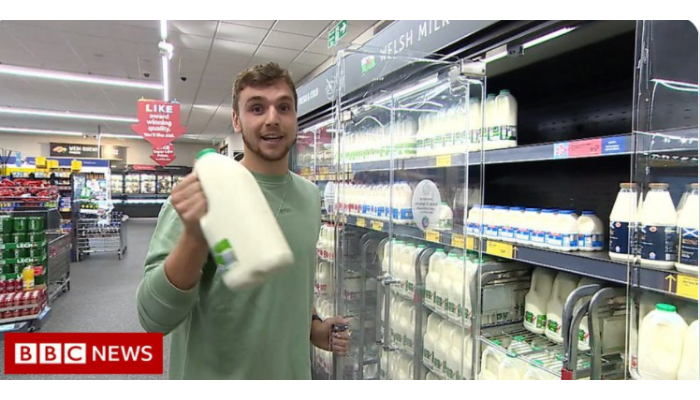 Picture of Joe Cooke in a supermarket getting something out of a fridge