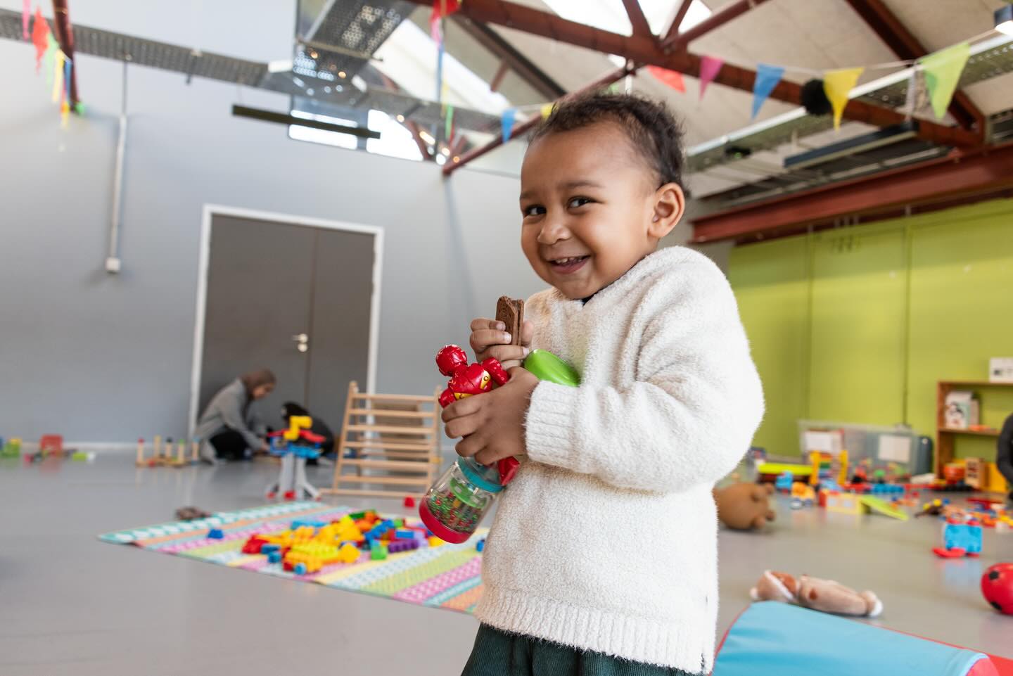 Photo of a toddler holding toys