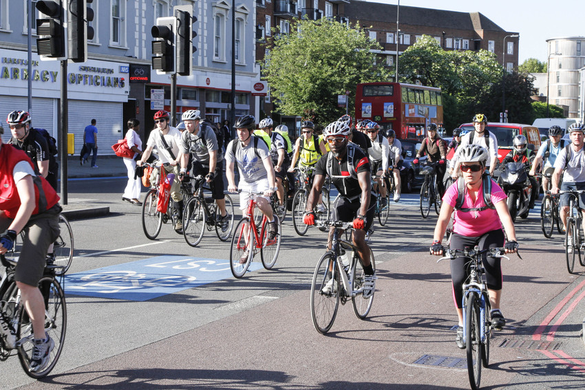 Picture of people cycling on a main road