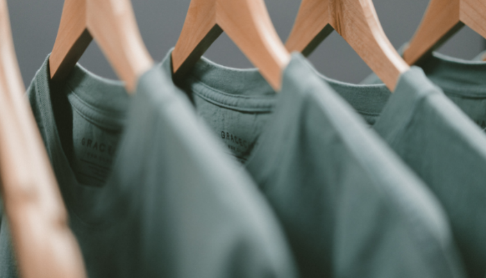 Picture of a row of teeshirts on clothes hangers