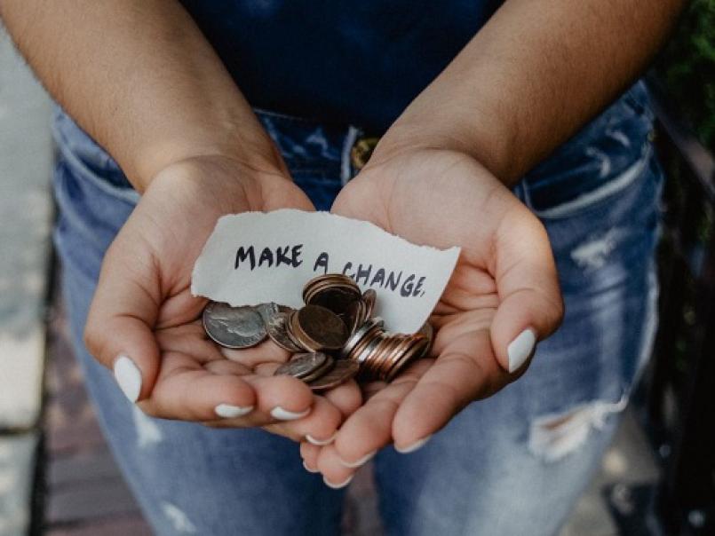 Someone holding coins and a note 'making a change'