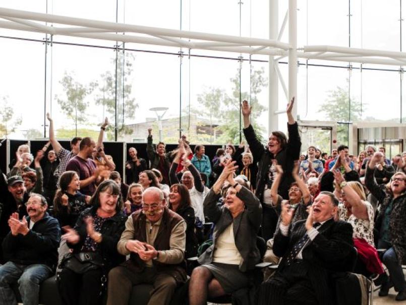 Picture of people in a hall, rejoicing