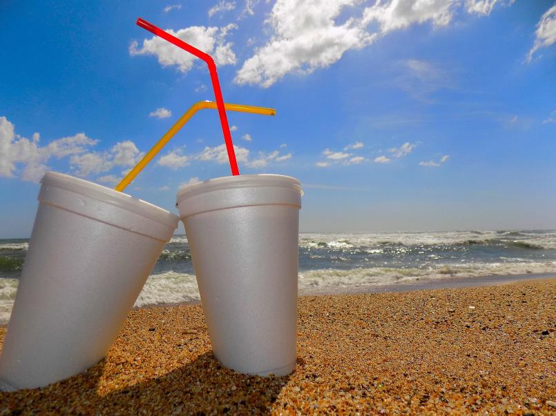 Two foam cups with plastic straws