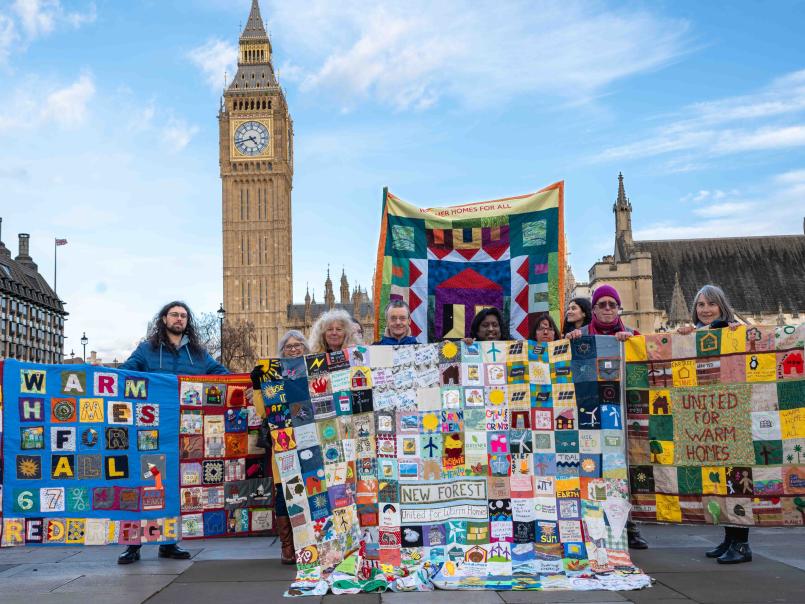 People with community quilts at Westminster