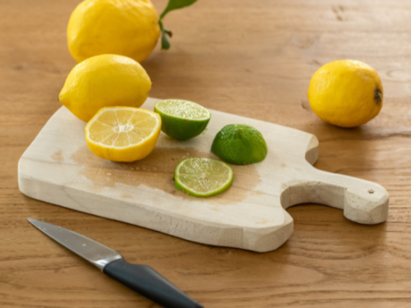 Lemons and limes on a chopping board