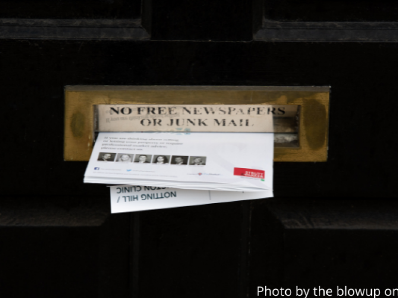 Junk mail being pushed through a letterbox