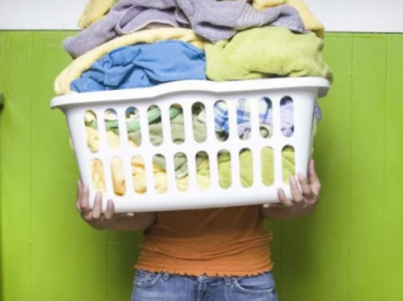 Someone holding a full laundry basket
