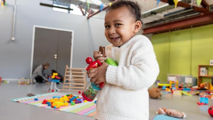Photo of a child holding toys